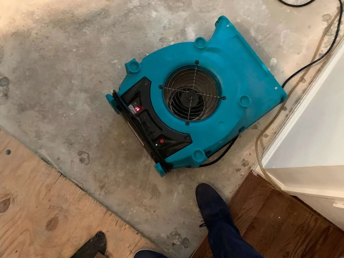 Air mover drying subfloor during Commercial Water Damage Restoration in Kenai
